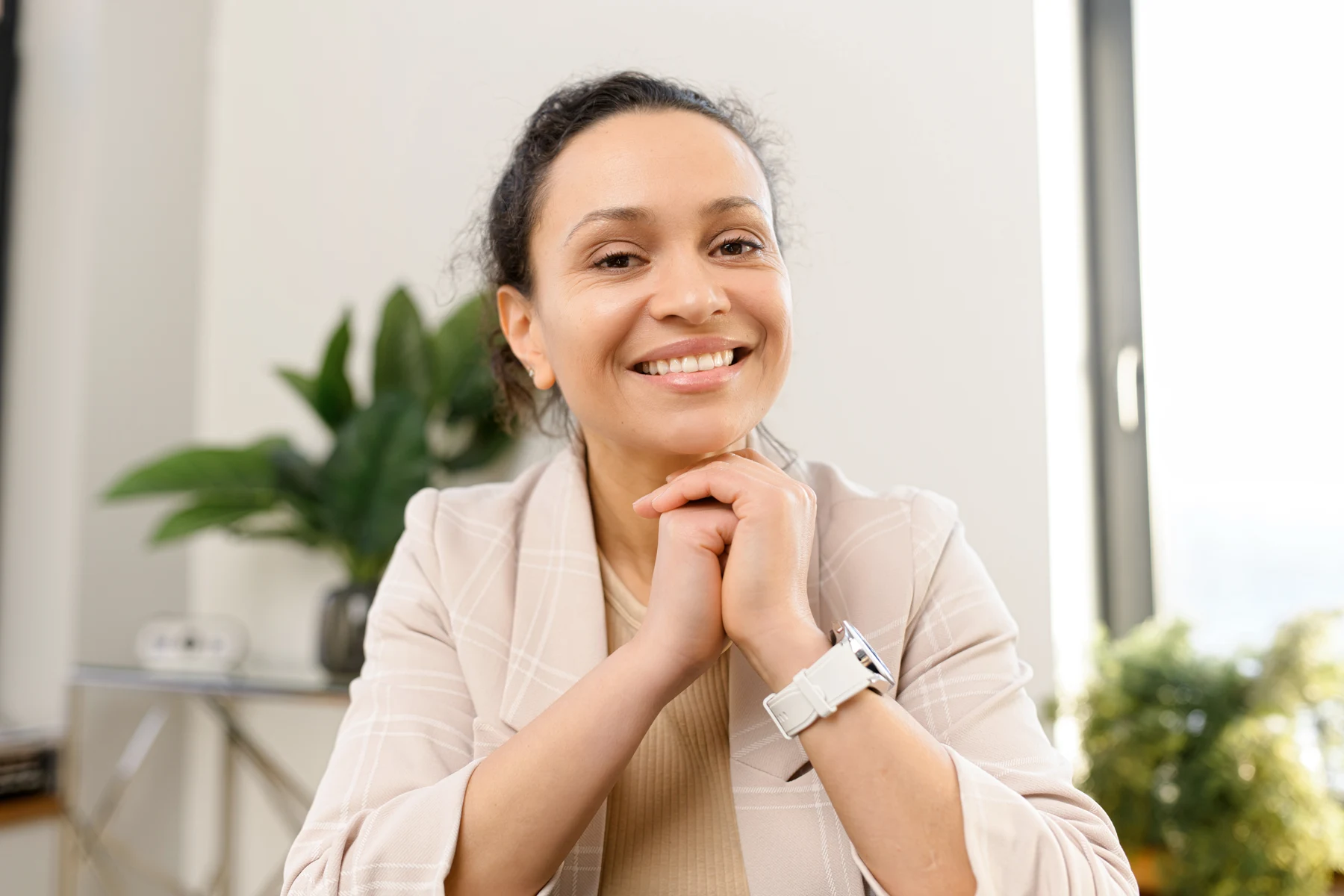 A woman listening attentively in a comfortable consultation setting.