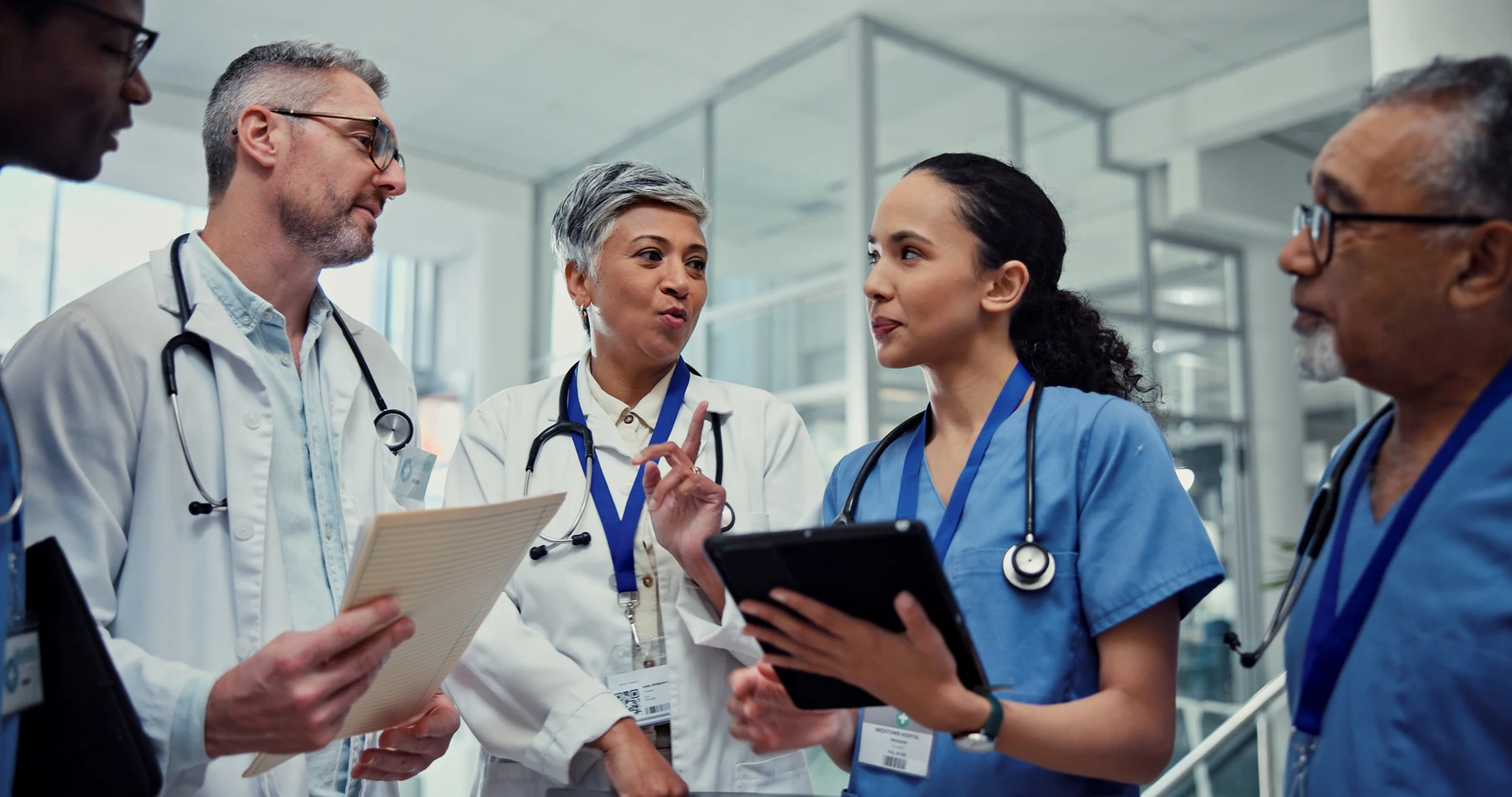 Healthcare professionals discussing care together in a clinical setting.